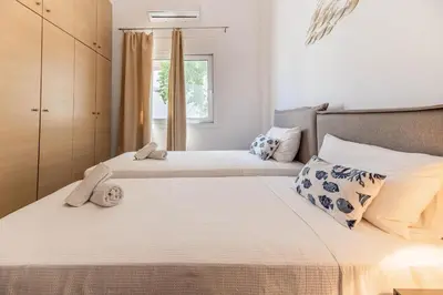a bedroom with two beds and a window at Kira's House Rhodes Town in Rhodes Town