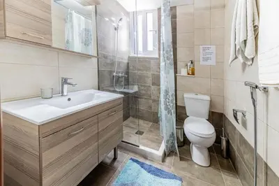 a bathroom with a sink and a toilet and a shower at Kira's House Rhodes Town in Rhodes Town