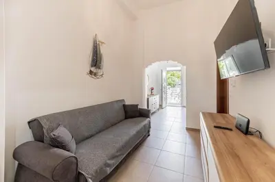a living room with a couch and a television at Kira's House Rhodes Town in Rhodes Town