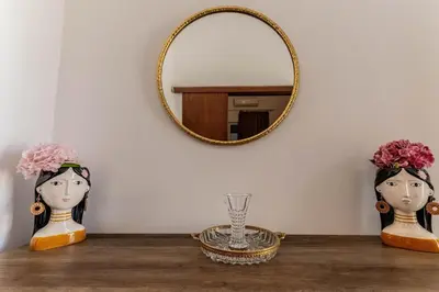 two dolls sitting on a table with a mirror at Kira's House Rhodes Town in Rhodes Town