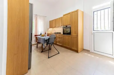 a kitchen with a table with chairs and a microwave at Kira's House Rhodes Town in Rhodes Town