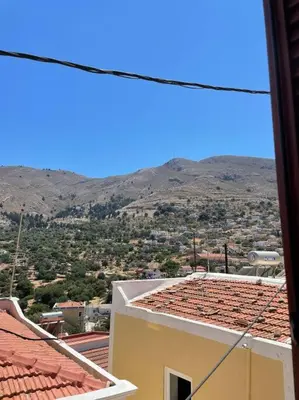 a view from a building with a mountain in the background at Foteini’s House in Symi