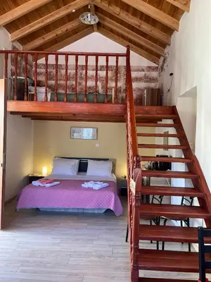a bedroom with a bunk bed and a staircase at Foteini’s House in Symi