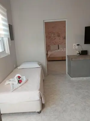 a white room with two beds and a mirror at Sunny house in Kremasti