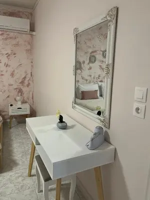 a room with a white table and a mirror at Sunny house in Kremasti