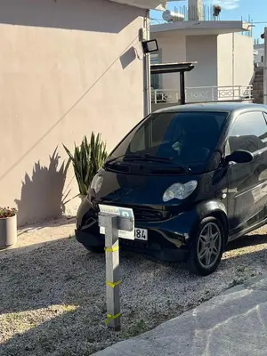 a small black car parked in front of a house at Sunny house in Kremasti