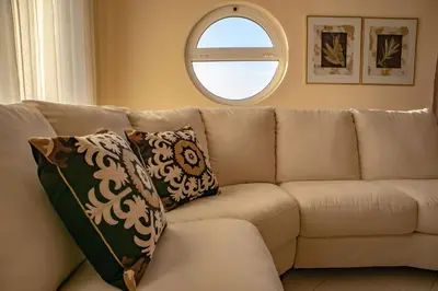 a couch with two pillows sitting in a living room at Mary's Luxury Residence in Koskinou
