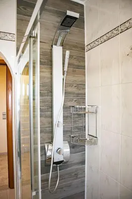 a shower in a bathroom with a mirror at Mary's Luxury Residence in Koskinou