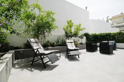 two chairs and a table on a patio at Rhodes Retreat: Modern Comfort in Serene Luxury in Rhodes Town