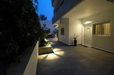 a walkway leading to a house at night at Rhodes Retreat: Modern Comfort in Serene Luxury in Rhodes Town