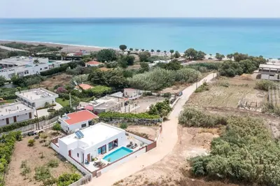 an aerial view of a house with the ocean in the background at SunDaLucky in Afantou