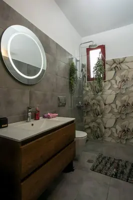 a bathroom with a sink and a mirror at SunDaLucky in Afantou