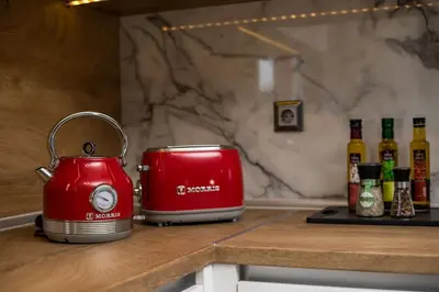 a red toaster sitting on top of a counter at SunDaLucky in Afantou