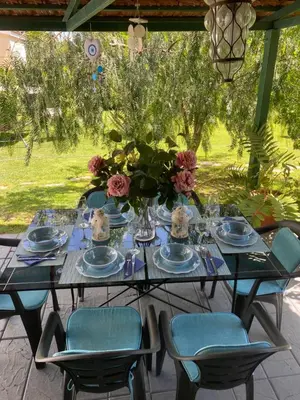 a table with a vase of flowers on it at Sunny Garden Villa Koskinou in Koskinou