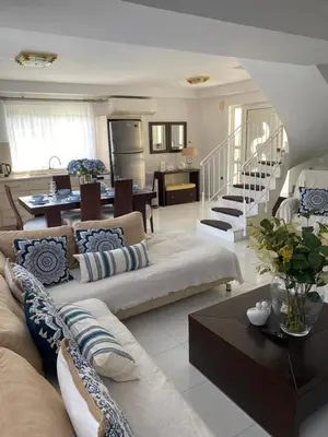 a living room with two couches and a dining room at Sunny Garden Villa Koskinou in Koskinou
