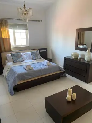 a bedroom with a bed and a table and a mirror at Sunny Garden Villa Koskinou in Koskinou
