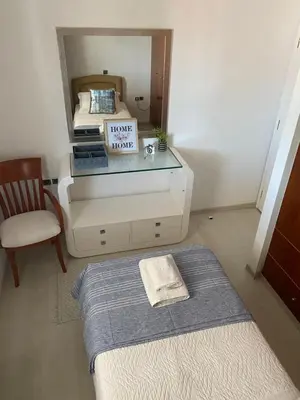 a room with a bed and a mirror with a dresser at Sunny Garden Villa Koskinou in Koskinou