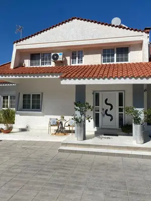 a white house with a sign on the door at Sunny Garden Villa Koskinou in Koskinou