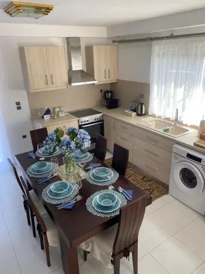 a kitchen with a table with blue and white dishes on it at Sunny Garden Villa Koskinou in Koskinou