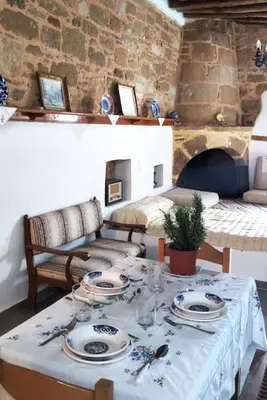 a table with plates and dishes on top of it at Heliophilia Malona in Malona Village