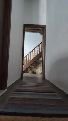 a hallway with a stairway leading to a room at Heliophilia Malona in Malona Village