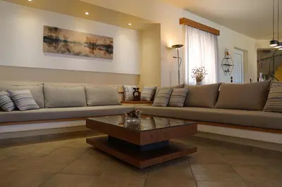 a living room with a couch and a coffee table at Villa Arco Bianco in Afantou