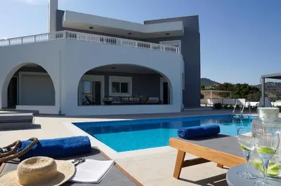 a villa with a swimming pool and a patio at Villa Arco Bianco in Afantou