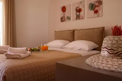 a bedroom with a bed with a bowl of fruit on it at Villa Arco Bianco in Afantou