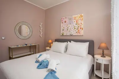 a bedroom with a white bed with towels on it at Thalia's House in Pastida