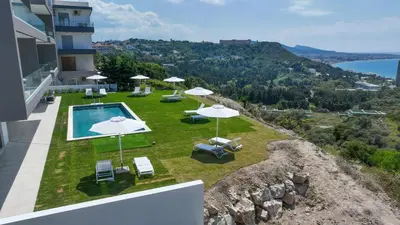 a pool with umbrellas and chairs on top of a building at Aquarama Pool Apt. - Blue in Ixia