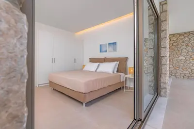 a bedroom with a bed and a mirror at Aegean View Estate - Villa in Faliraki