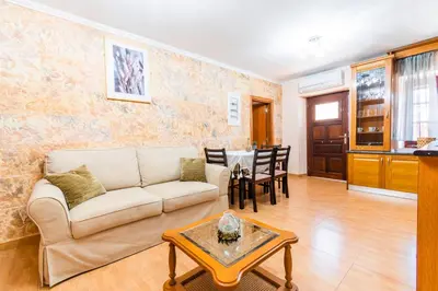 a living room with a couch and a table at EIRINI in Symi