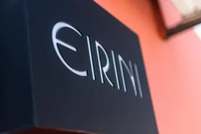 a close up of the clm logo on a wall at EIRINI in Symi