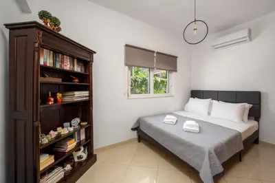 a bedroom with a bed and a book shelf at Aelia Luxury Villa in Sálakos