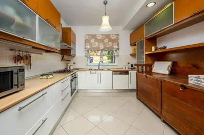 a kitchen with white counters and wooden cabinets at Aelia Luxury Villa in Sálakos