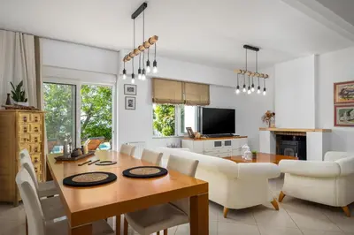 a dining room and living room with a table and chairs at Aelia Luxury Villa in Sálakos