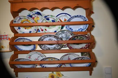 a bunch of plates on shelves in a wall at Anthias Beach Home in Archangelos