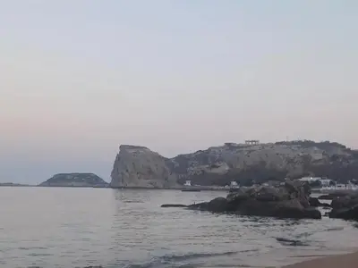 a body of water with a mountain in the background at Anthias Beach Home in Archangelos