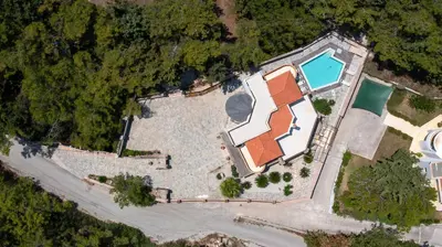 an overhead view of a building with a swimming pool at Glamorous Villa Nefeli in Koskinou