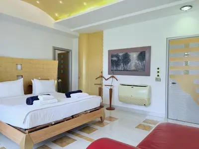a bedroom with a large bed and a bathroom at Grande Dame Villa of Rhodes in Rhodes Town
