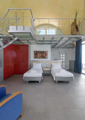 a room with two beds and a ceiling with windows at Grande Dame Villa of Rhodes in Rhodes Town