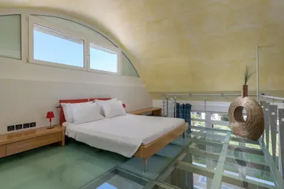 a bedroom with a bed and a glass floor at Grande Dame Villa of Rhodes in Rhodes Town