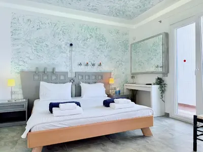 a bedroom with a large bed with two pillows on it at Grande Dame Villa of Rhodes in Rhodes Town