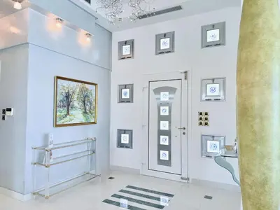 a white room with a door and pictures on the wall at Grande Dame Villa of Rhodes in Rhodes Town