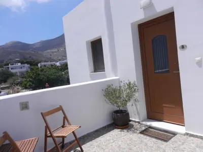 a balcony with chairs and a door with a view at ANEMOESSA APTS in Livadia