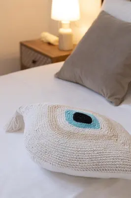 a crocheted animal shaped pillow on a bed at VillaBlu Apartments in Asgourou