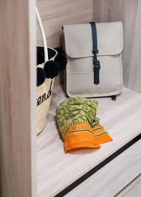 a bag and a towel on a shelf with a bag at VillaBlu Apartments in Asgourou