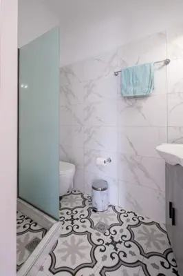 a bathroom with a toilet and a sink at VillaBlu Apartments in Asgourou