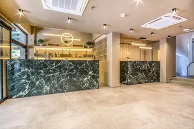 a lobby of a hotel with a marble counter at Astron Hotel Rhodes in Rhodes Town