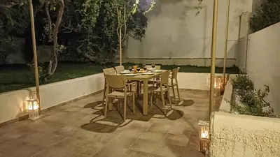 a table and chairs on a patio with lights at Dimitra - Kattavia surf houses in Kattavía